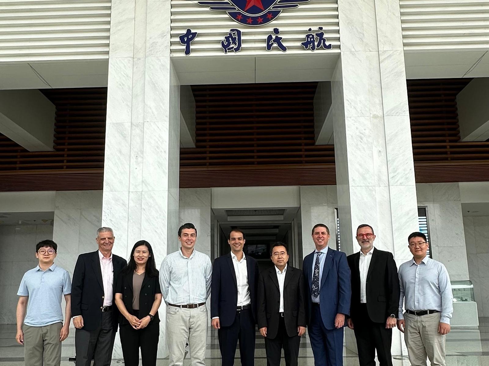 Delegates standing on the steps of the Civil Aviation Administration of China headquarters in Beijing