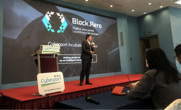 Lucas Pinoli presenting on stage at Cyberport